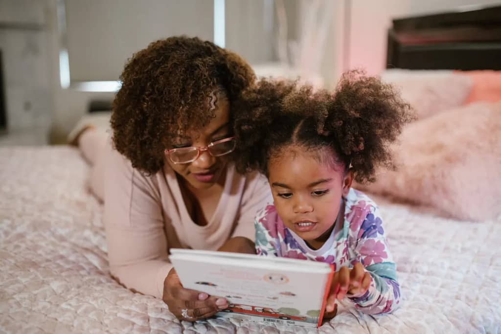 a mom and daughter reading about the fruit of the spirit joy.