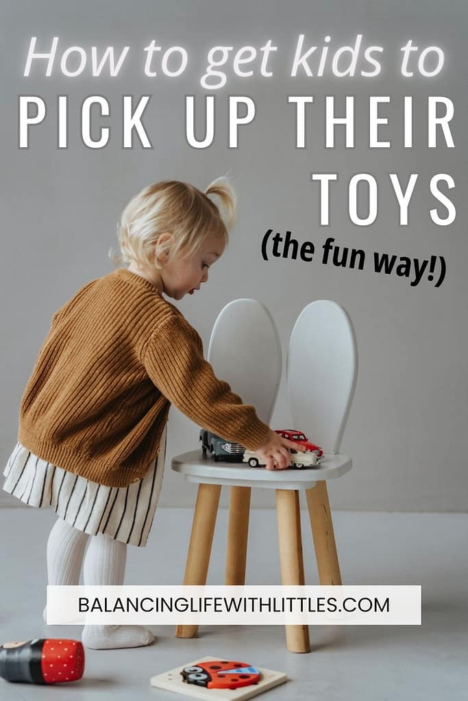 Pin image with blog post title. A 2 year old girl is picking up a car to put it away.